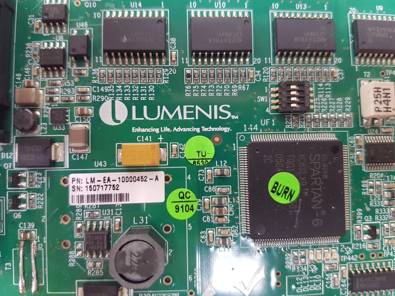 Close-up of the LM-EA-10000452-A label and the Xilinx Spartan-6 FPGA on the Lumenis MMCU board