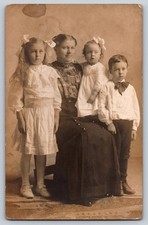 Mother with Three Children – White Dresses & Bows – c.1900s Studio Photo