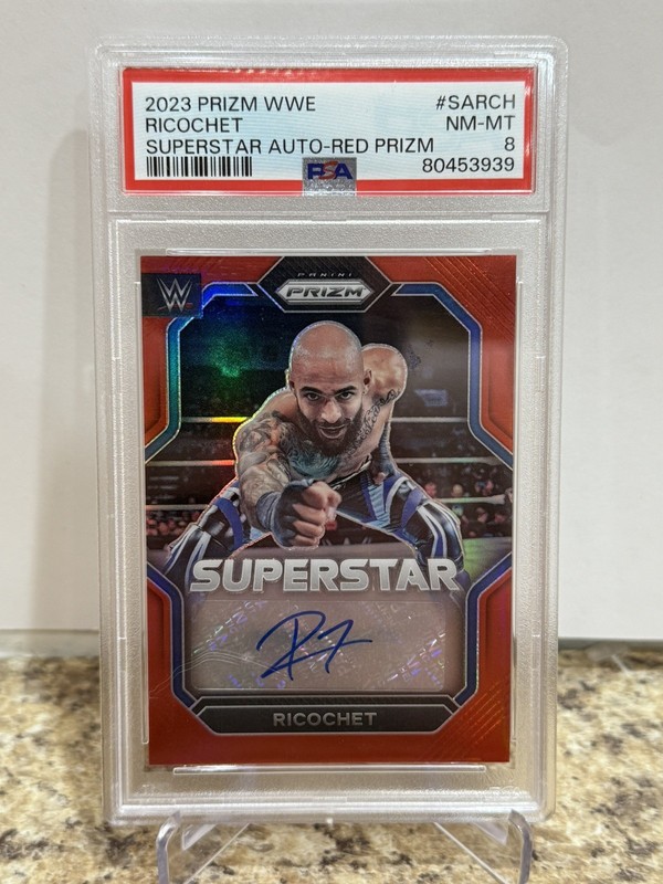 2023 Panini Prizm WWE - Superstar Autographs Ricochet #SA-RCH Red Prizm /99 PSA8