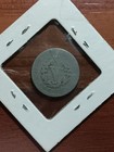 1910 Liberty Head V nickel with worn details, surrounded by white cardboard frame with metal rivets.