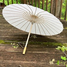 Wood or bamboo and paper collapsable parasol. Looks very Japanese 