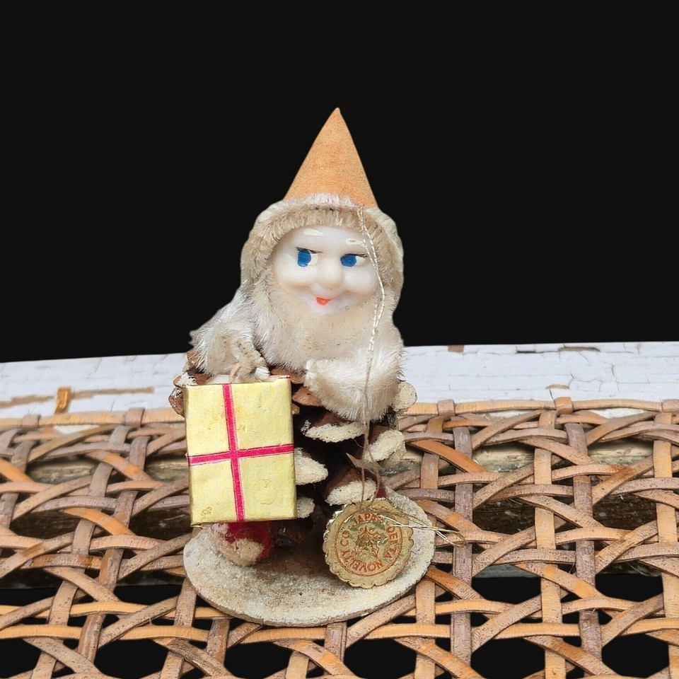 A rare Putz-style pinecone pixie elf ornament straight from mid-century Japan, complete with original hang tag — the kind of piece serious vintage collectors actually hunt for.
