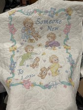 Vintage cross stitch baby quilt, featuring a "Someone New to Love"