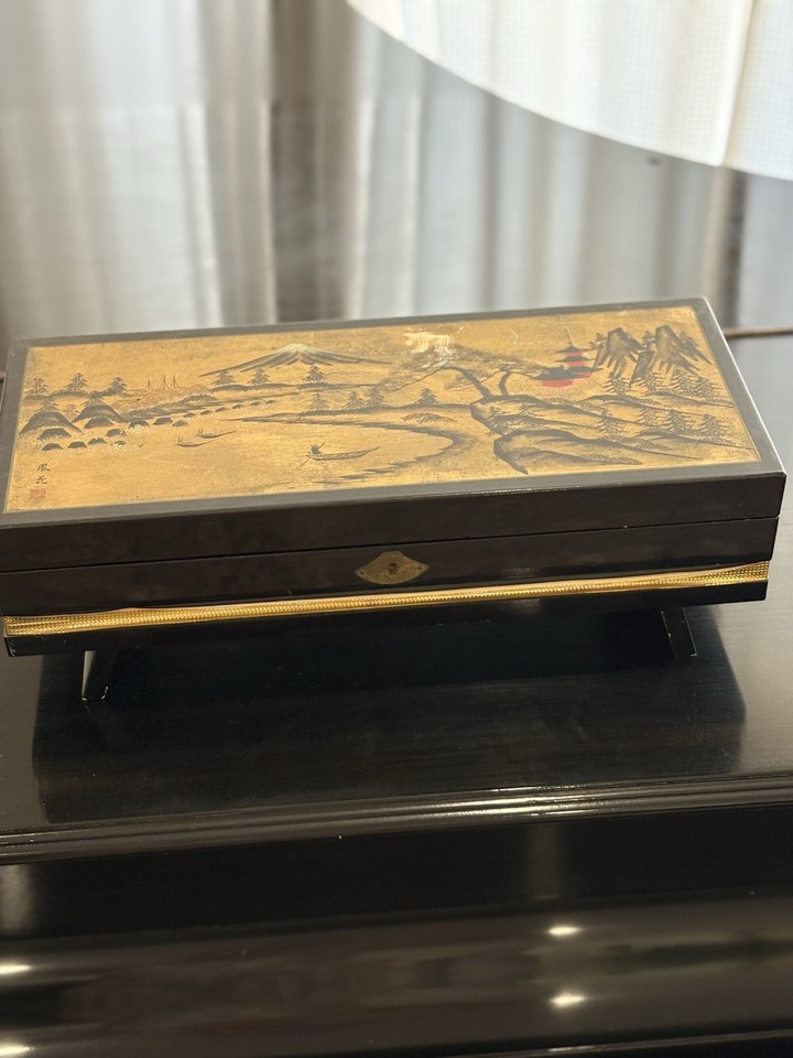 A Japanese black lacquer ballerina music box — gorgeous tactile object even with the dancer missing, pure vintage aesthetic.