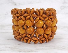 Wide light brown wood stretch bracelet with a mix of round and disk wood beads