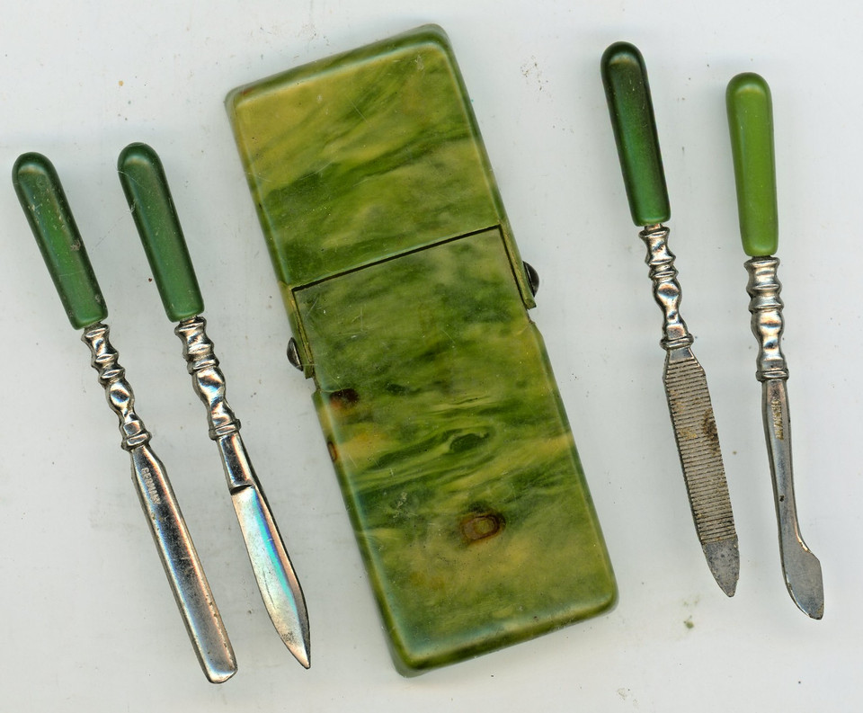 A sleek mid-century German travel manicure set in jade-green Bakelite — functional vintage EDC that looks like a prop from a spy film.