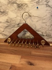 wooden hanger with metal hooks for accessory organization