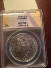 1889 O Morgan silver dollar AU 50 Details Cleaned GreySheet price $ 110 (3)
