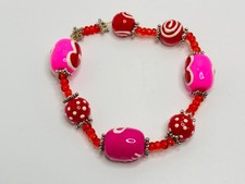 Colorful pink and red beaded stretch bracelet