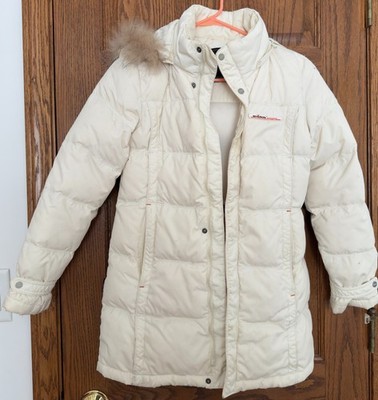 Down jacket features a hood with a light-colored faux fur trim for girls