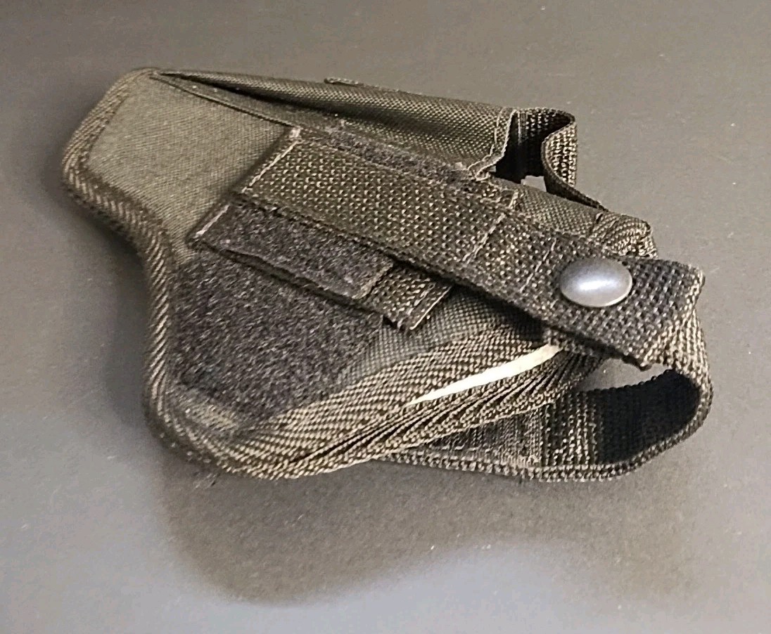 Black nylon IWB holster with double stitching, belt loop, and silver snap closure on a gray background.