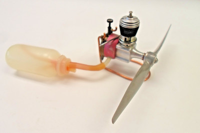 Vintage COX .020 glow engine with R/C exhaust throttle and 1 oz external tank