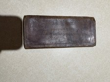 vintage leather billfold wallet with red interior card slots.