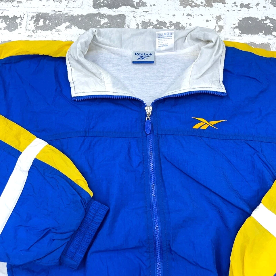 Chaqueta cortavientos vintage Reebok para mujer XL azul amarillo traje de pista cremallera completa años 90 Foto 3 de 4