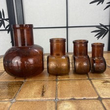 Collection Of  Four Small Antique Brown Glass Bottles. Bovril Limited