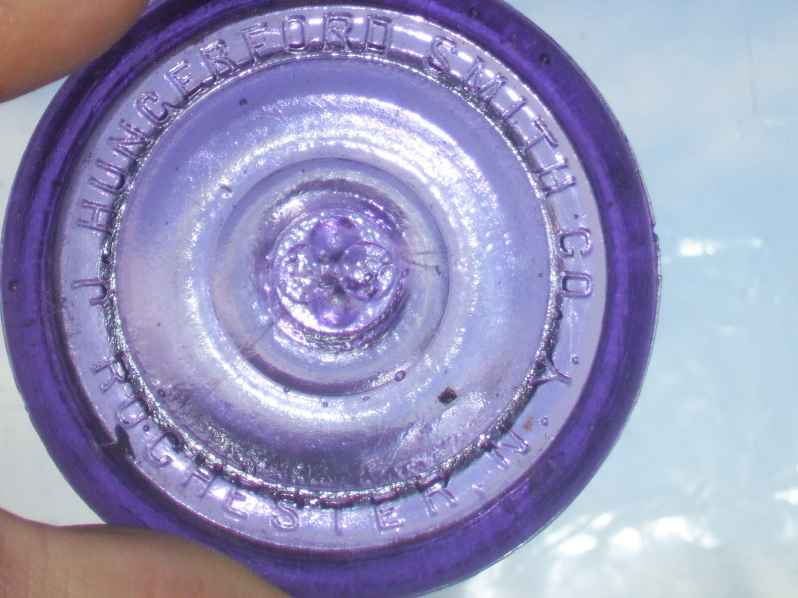 Dark purple J, Hungerford Smith co. Rochester, N. Y. glass top canning jar lid