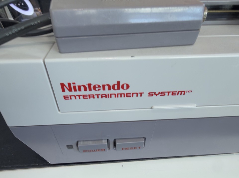 A genuine piece of 80s/90s gaming history — the NES Game Genie was THE cheat-code device every kid begged for, and bundled with 13 games it's a ready-to-play retro time capsule.