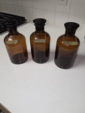 Vintage Amber Glass Bottles With Vermouth, Gin, And Campari Brass Tags