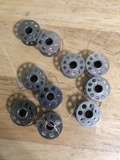 TEN VINTAGE METAL BOBBINS in Plastic Case, No Rust, Great Condition.