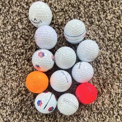 12 Golf balls in great condition, comes in a white bag, 10 whites (3 designs).