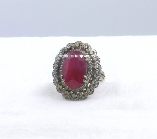 Real ruby single cut diamond ring with round bezel, set in 925 sterling silver, on white Victorian jewelry box.