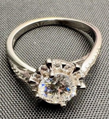 Luxury women's ring featuring a brilliant round-cut Moissanite center stone