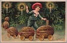 c1910s MERRY CHRISTMAS Embossed Postcard Little Boy with Walnut Shell Train