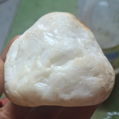 milky-white tumbled stone that appears to be a natural mineral specimen.