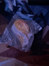  This is a yellow McDonald's 1990 Sports Ball Happy Meal toy, likely a football