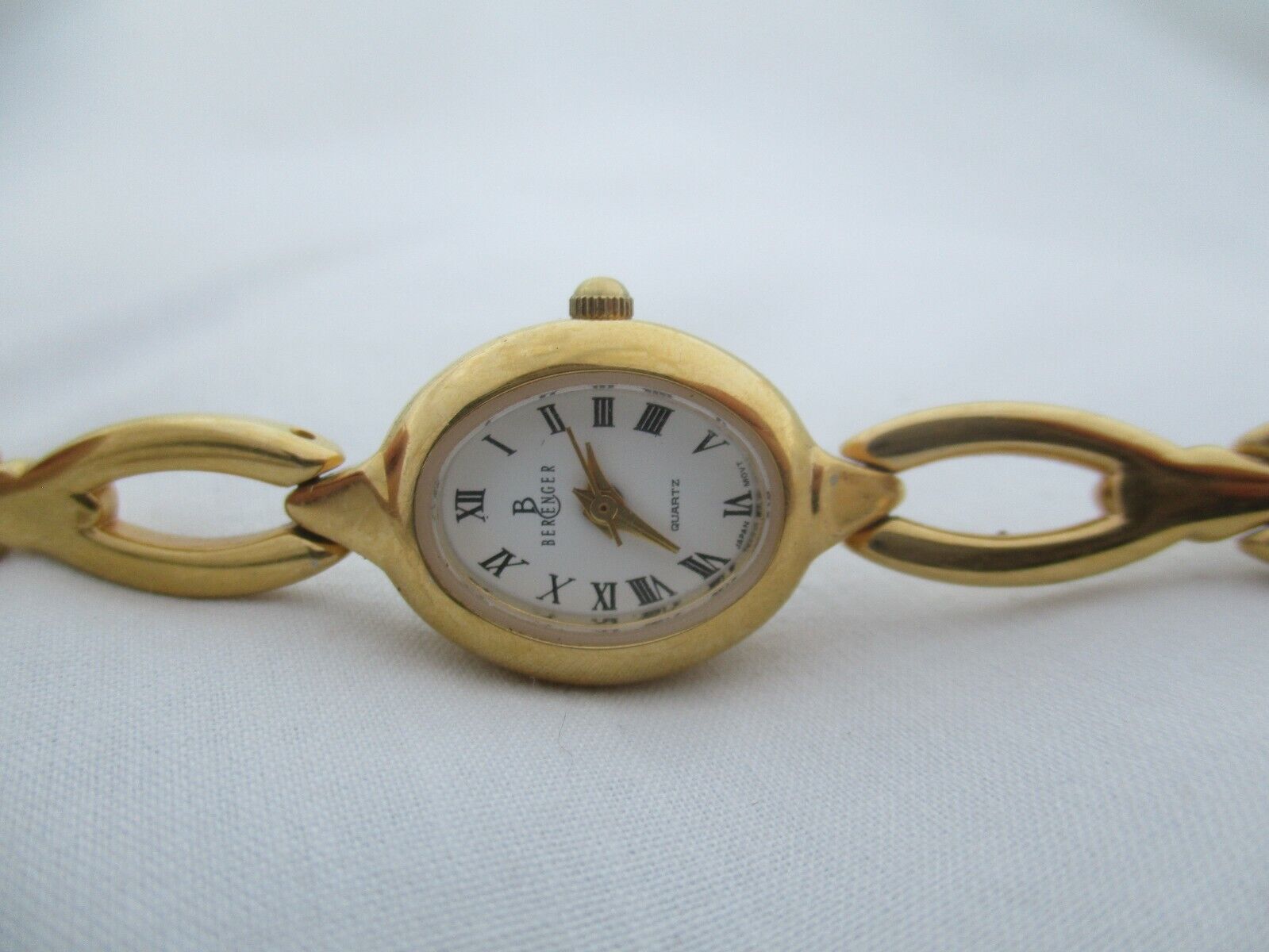 Berenger Wristwatch Gold Tone Band Oval Shaped White Face Roman Numerals