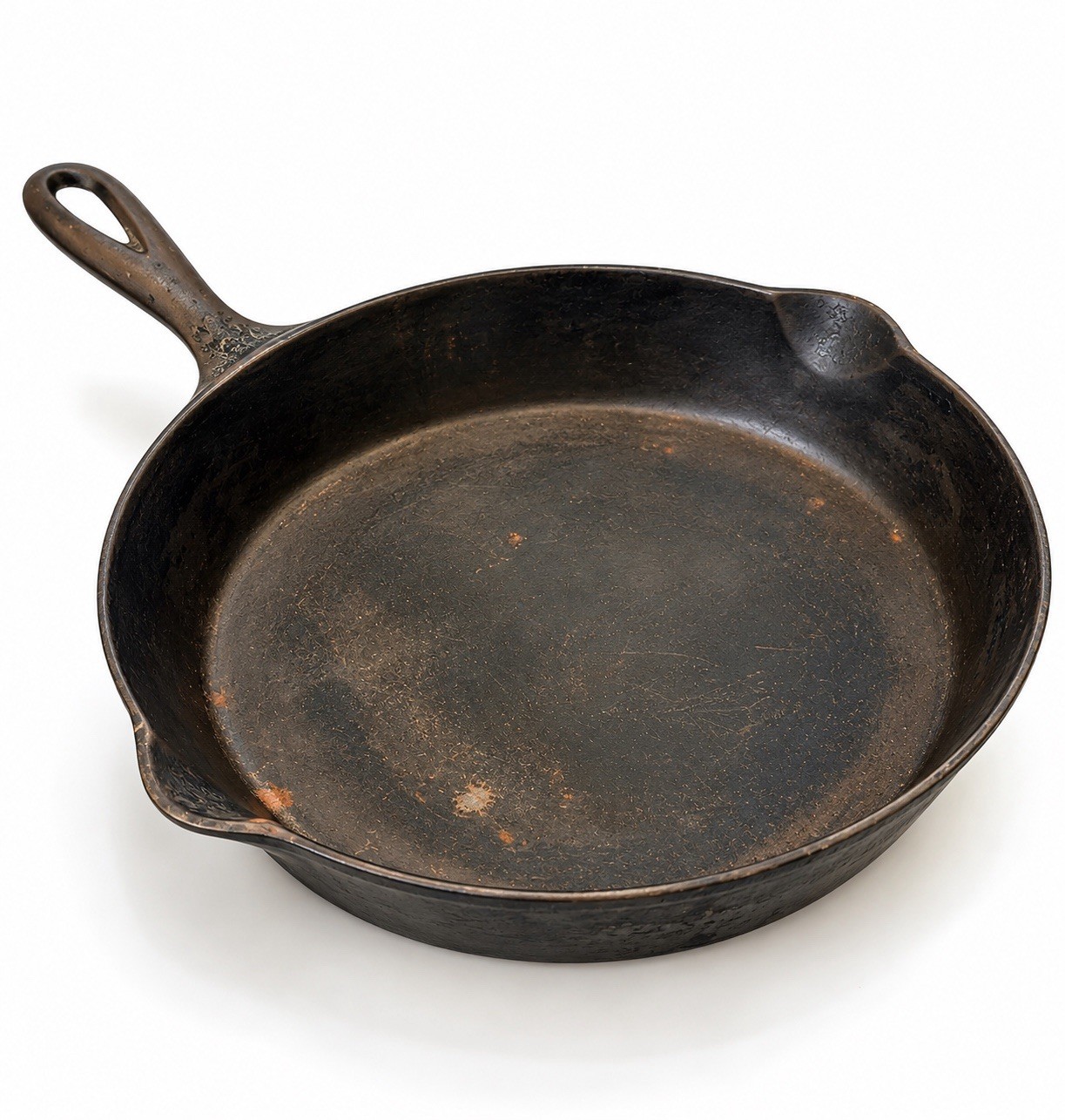 Large antique unmarked cast iron skillet with a raised heat ring on the underside and long handle.