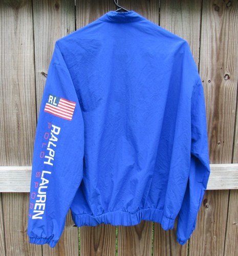 Royal blue Vtg 90s Polo Sport Ralph Lauren jacket with black strap, red, white, and blue chest stripes, and visible RL logo.
