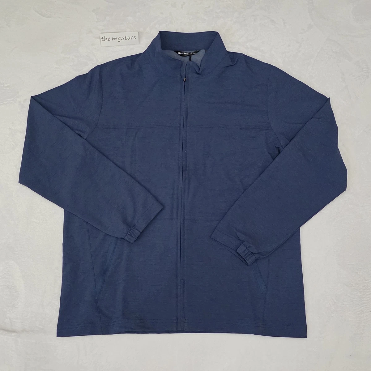 Veste Travis Mathew homme grand coupe-vent bleu col faux poches zippées