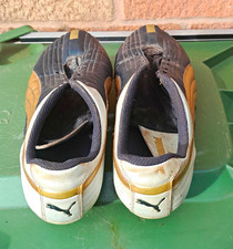 Well used Puma football boots and shin pads. REQUIRE LACES.
