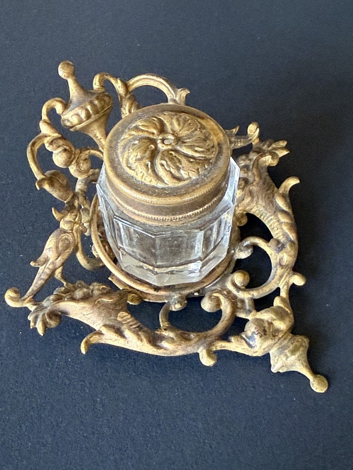 An 1880s Victorian Rococo brass inkwell with its original glass insert — a literal antique that survived 140+ years and still looks spectacular.