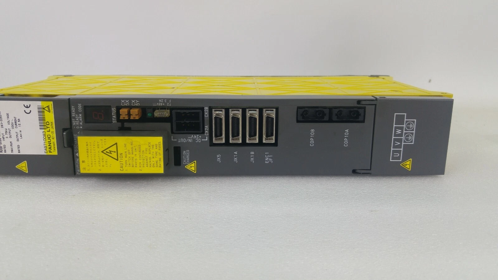 Front panel of the FANUC servo amplifier: status display, JX5, JX1A, JX1B, JF1, COP10A/B, U V W