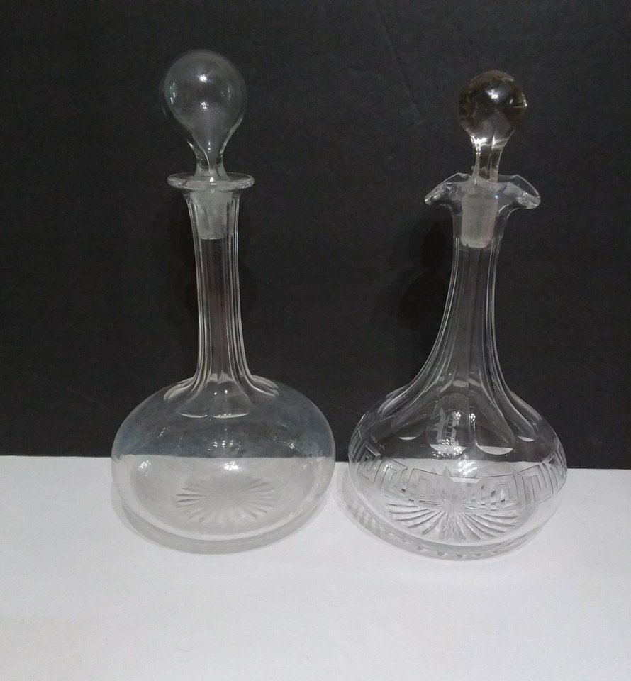 A matched pair of Art Deco crystal decanters — geometric, glamorous, and ready to make any sideboard look like a 1930s speakeasy.