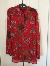 womans red floral long sleeved blouse
