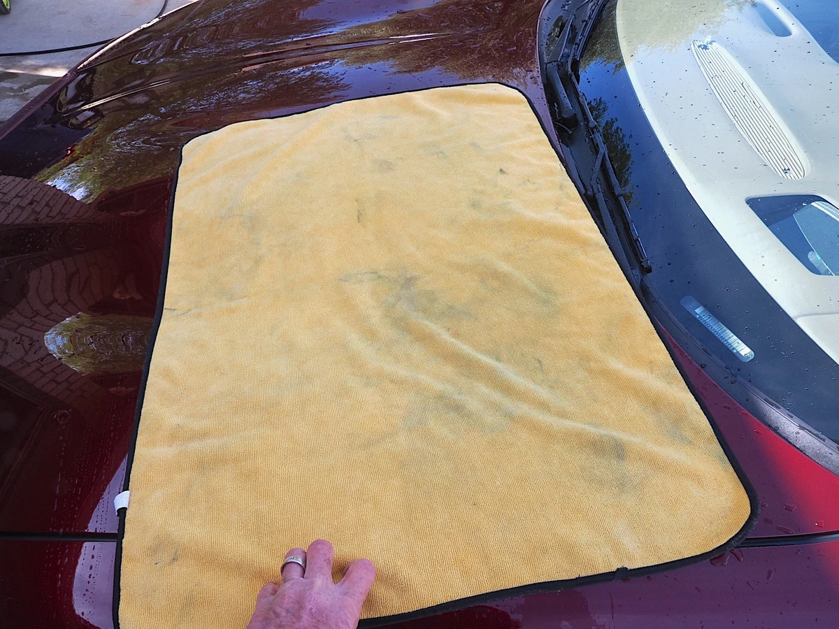 Dragging a microfiber towel after washing your car to remove water