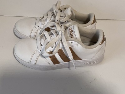 white shoes with golden stripes