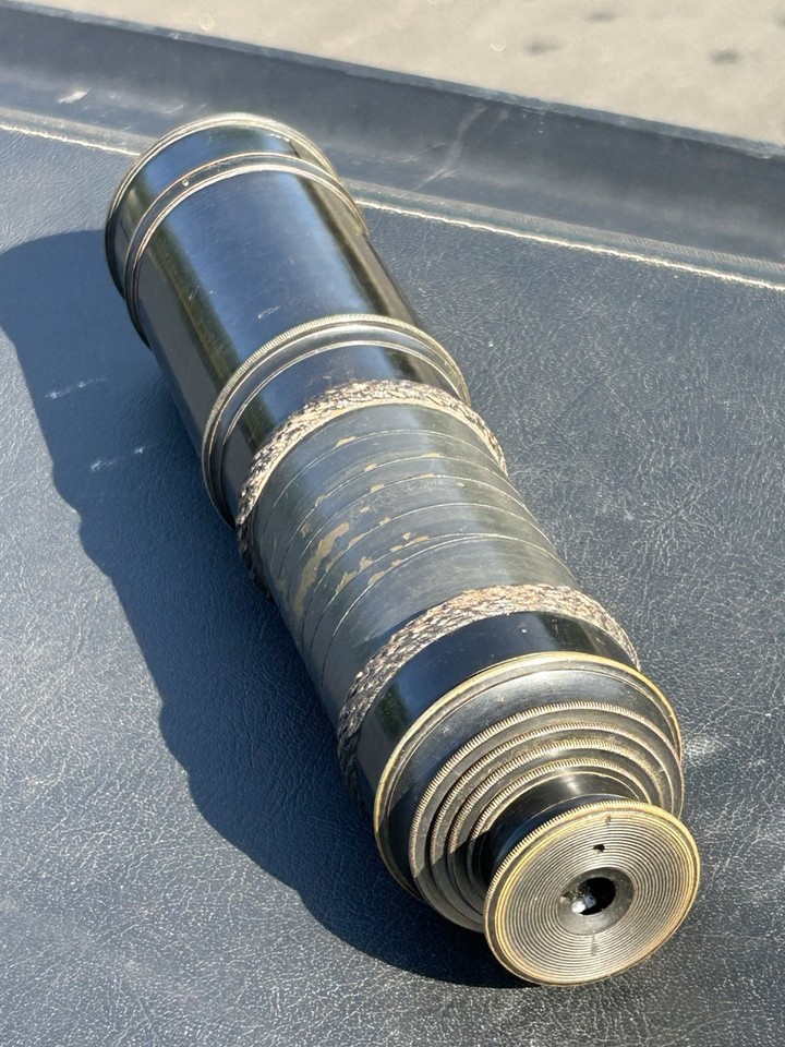 A genuine antique 4-draw brass & leather telescope from the early 20th century — the kind of object that instantly becomes the centerpiece of any study or mantelpiece.