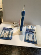 Braun Oral-B Electric Toothbrush With Base, Case, And 11 Replacement Heads