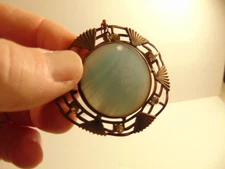 Broken or incomplete intage brass colored pin or pendant with large blue jewel 