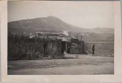1955 Photo of Barracks Area Hidden by High Thatch Wall at Base