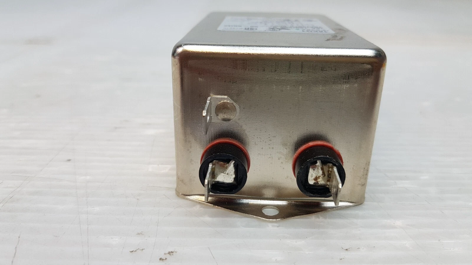 End of the 16EQ1 filter with two quick-connect tabs, ground tab and flange