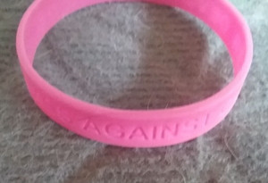 PINK PLASTIC WRISTBAND " DEVOTED TO A CURE - COSMOS AGAINST CANCER "