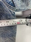 Blue vintage Levi’s 1980s trucker jacket with metal rivets, front pockets, and visible white Sherpa-lined denim.