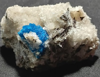 Rare, electric-blue cavansite nestled on sparkling, frosty-white zeolites