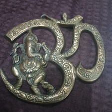 Bronze Coloured Metal Wall Hanging Featuring Lord Ganesha Seated In The Om Symbo