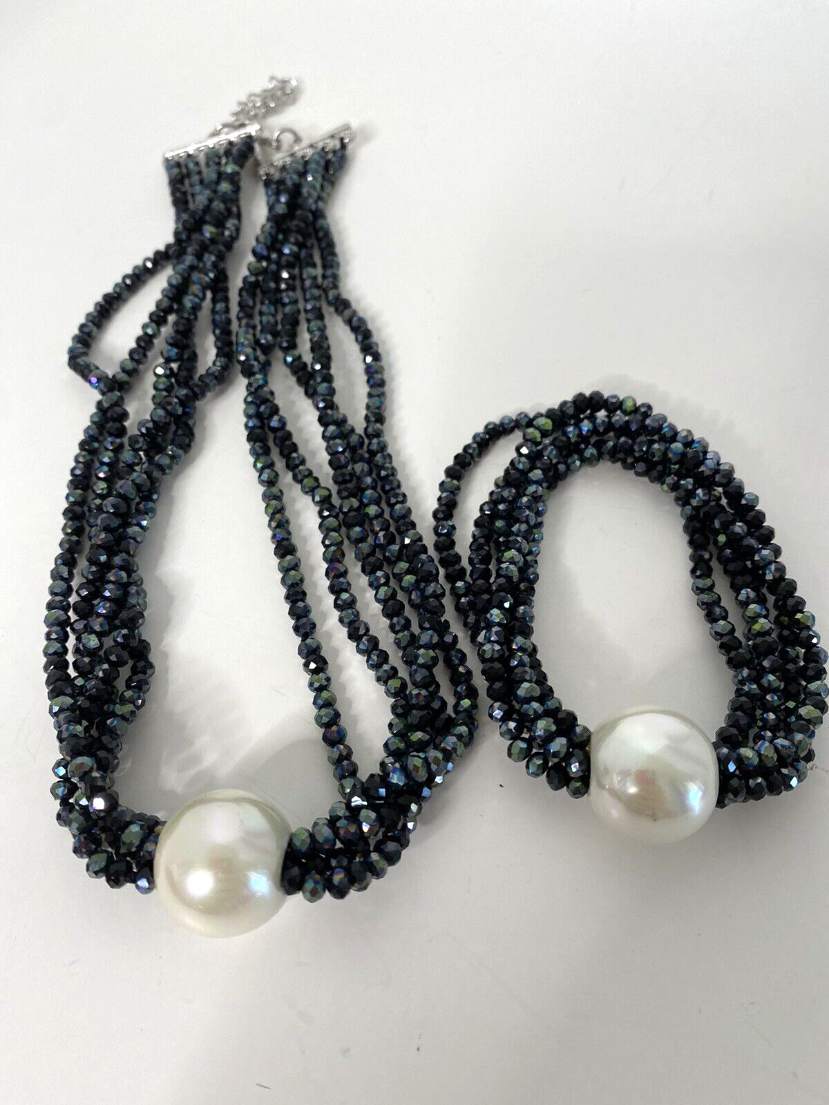 black beaded with one big pearl necklace and bracelet